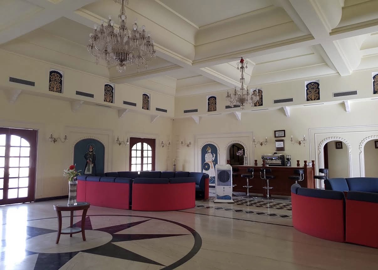 Heritage lobby of the venue with chandeliers and painted Rajasthani frescoes