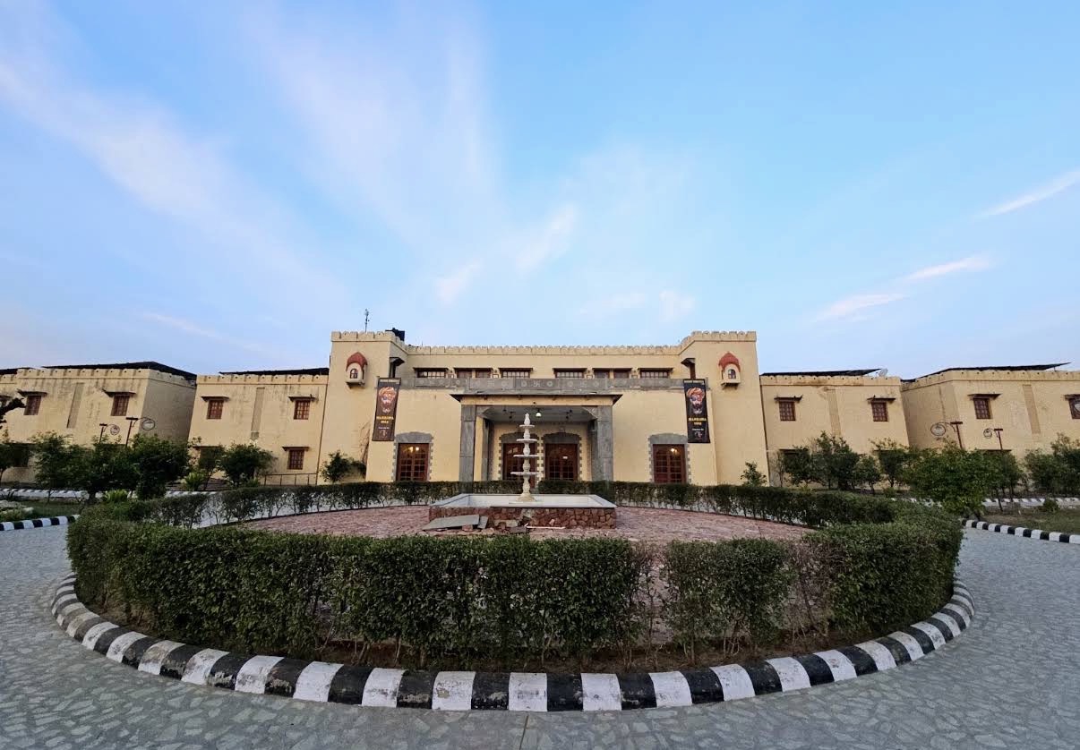 Sandstone fort-style facade of the wedding venue in Mandawa at dusk